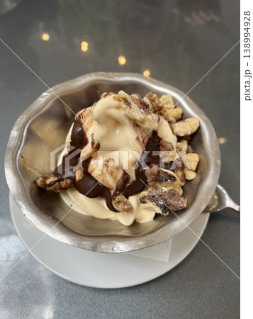 Sweet ice cream in a bowl on the table in a coffee shop. 138994928
