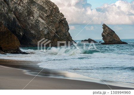 Praia da Adraga Coastal Archway in Sintra Portugal, beautiful beach with rocks in the sea ocean Praia da Adraga Coastal Archway in Sintra Portugal, beautiful beach with rocks in the sea ocean 138994960