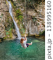Rope Swing by Waterfall in Lush Forest Summer Travel Destination 138995160