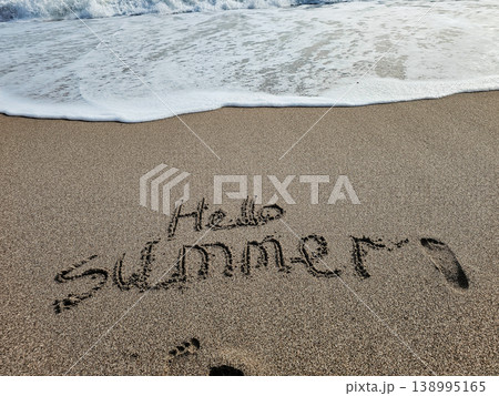 Hello Summer Written in Sand with Sea Foam Top View Beach Concept Hello Summer Written in Sand with Sea Foam Top View Beach Concept 138995165