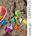 Colorful Kids Sand Toys and Water Gun on Sandy Beach Close Up 138995172