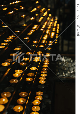 Burning candles in an old church. 138995224