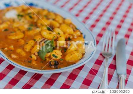A plate of traditional Italian dish gnocchi for lunch in a cafe. A plate of traditional Italian dish gnocchi for lunch in a cafe. 138995290