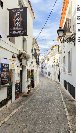 Exploring Altea's charming old town street, a picturesque Spanish village perfect for memorable family holidays and vacation trips Exploring Altea's charming old town street, a picturesque Spanish village perfect for memorable family holidays and vacation trips 138995897