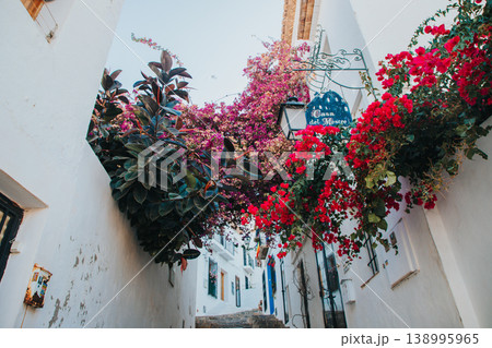 Exploring Altea Spain's charming narrow street adorned with vibrant bougainvillea and historic whitewashed buildings ideal for family holidays 138995965
