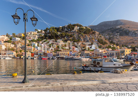 Sailboats in harbor with hillside houses in Symi, Greece 138997520