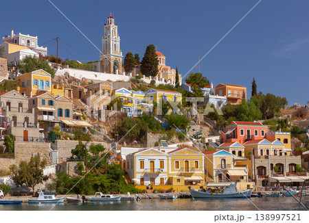 Sailboats in harbor with hillside houses in Symi, Greece 138997521