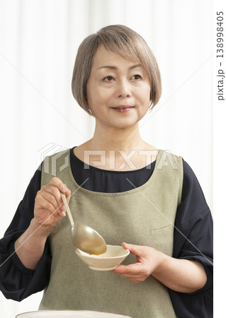 キッチンでベジブロスを作るシニア女性 138998405