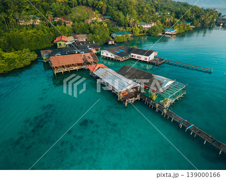 Aerial view of a traditional coastal village living in harmony with nature, showcasing sustainable living and slow life. 139000166