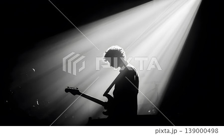 Musician guitarist silhouette concert stage spotlight electric guitar performance backlit monochrome, musician silhouette with electric guitar concert stage dramatic spotlight, moody black 139000498