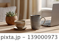 Coffee ceramic mug laptop succulent wooden table home office soft light morning workspace minimalist coffee cup and ceramic mug near laptop and succulent wooden table home office, soft morning 139000973
