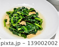 Serving of simple but delicious Chinese stir fried pea shoots or sprout vegetable in Beijing 139002002