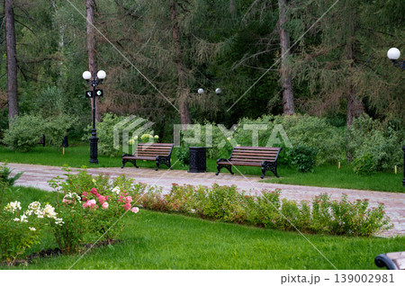 Beautifully landscaped garden with stone facade and vibrant greenery. 139002981