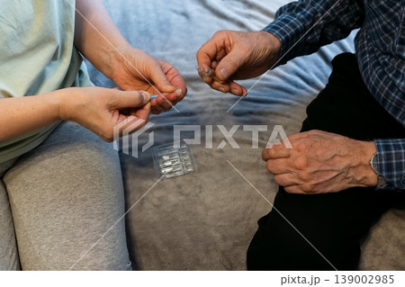 Nurse administers vaccine to patient in healthcare setting during daytime 139002985