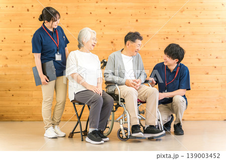介護施設にいるシニア男女と言語聴覚士・理学療法士の男性(デイサービス,老人ホーム) 介護施設にいるシニア男女と言語聴覚士・理学療法士の男性(デイサービス,老人ホーム) 139003452