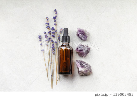 Lavender and Amethyst with Essential Oil Bottle on Neutral Background Lavender and Amethyst with Essential Oil Bottle on Neutral Background 139003483