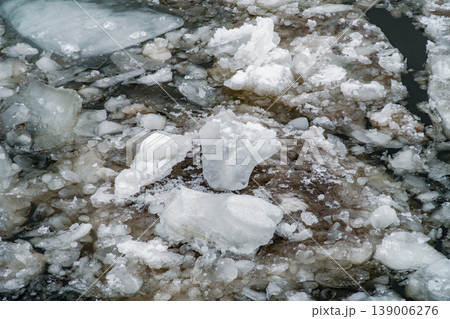 Ice Floes and Broken River Ice Floating on Dark Water in Late Winter Morning 139006276