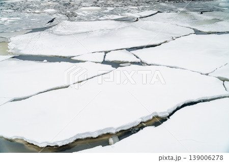 Ice Floes and Broken River Ice Floating on Dark Water in Late Winter Morning 139006278