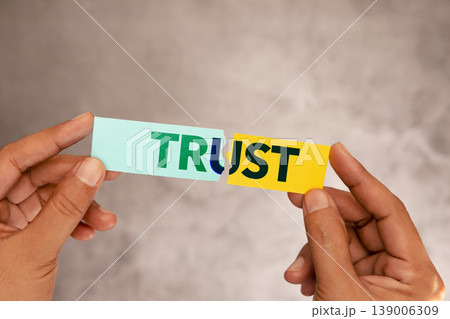 Hands tearing paper with word trust, broken relationship concept, trust issues Hands tearing paper with word trust, broken relationship concept, trust issues 139006309
