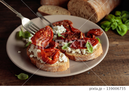 Ciabatta with sun dried tomatoes in olive oil, ricotta, and basil. Ciabatta with sun dried tomatoes in olive oil, ricotta, and basil. 139006735
