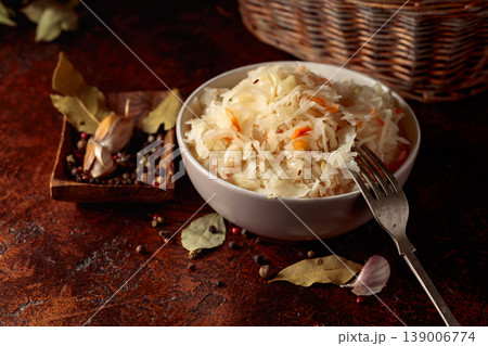 Sauerkraut with ingredients on a rustic background. Sauerkraut with ingredients on a rustic background. 139006774