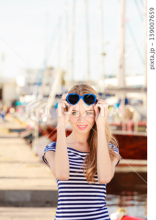 woman in marina against yachts in port woman in marina against yachts in port 139007659
