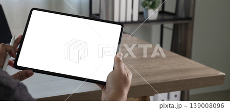 Hands holding tablet with blank screen while using stylus for interface design mockup, replaces your design mockup, digital content layout, and user interaction workflow on desk Hands holding tablet with blank screen while using stylus for interface design mockup, replaces your design mockup, digital content layout, and user interaction workflow on desk 139008096