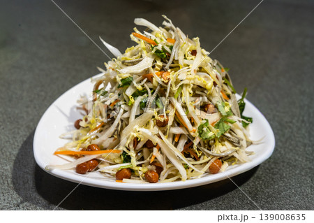 Serving of Chinese specialty cold salad with cabbage and groundnuts as appetizer. 139008635