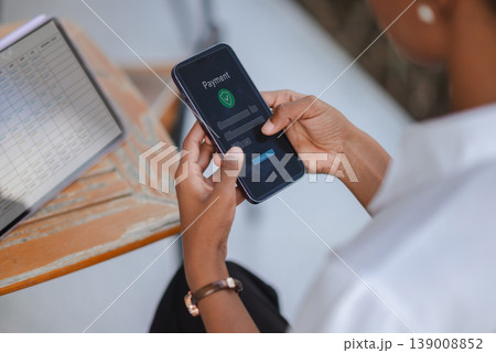 Close up of hands using smartphone with online payment interface beside tablet spreadsheet, concept of digital payment, fintech, ecommerce checkout, business finance and secure transaction. Close up of hands using smartphone with online payment interface beside tablet spreadsheet, concept of digital payment, fintech, ecommerce checkout, business finance and secure transaction. 139008852