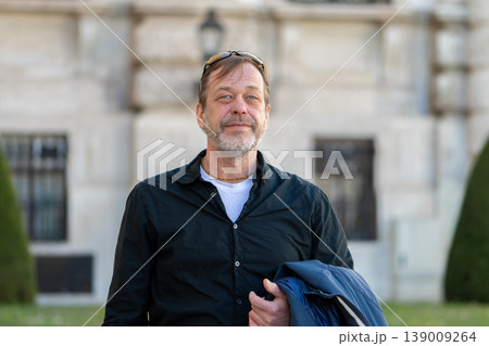Man 50-55 years old standing outdoors showing confidence calm and experience Man 50-55 years old standing outdoors showing confidence calm and experience 139009264