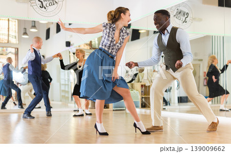 Man and woman performing jazz dance in dancing room 139009662