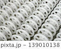 White plastic rollers of industrial conveyor, production, sorting, or transportation line 139010138