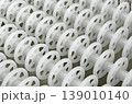 White plastic rollers of industrial conveyor, production, sorting, or transportation line 139010140