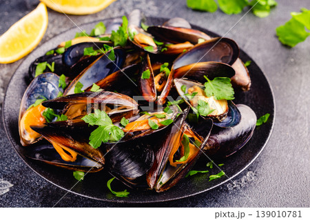 Delicious seafood mussels with sauce and parsley. Delicious seafood mussels with sauce and parsley. 139010781