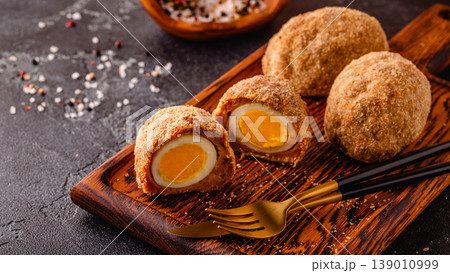 Traditional Scotch Eggs on a wooden board. 139010999