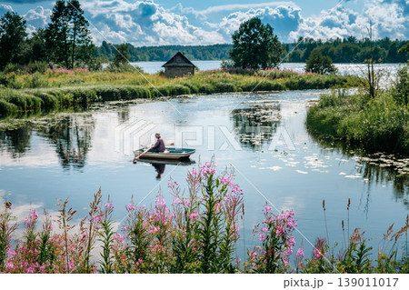 A man is fishing in a boat. A man is fishing in a boat. 139011017
