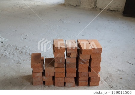 Complex bricks stacked on a concrete floor.の写真素材 [139011506] - PIXTA