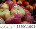 Closeup apples in the pile in the fruit shop with defocused red apple pile in background 139011908