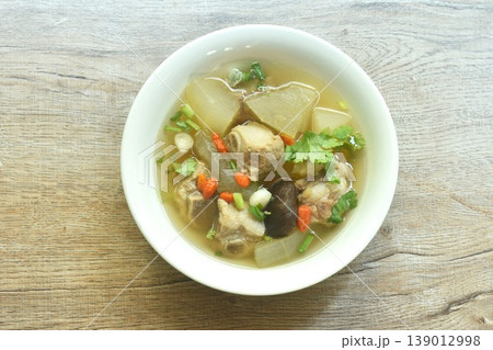 boiled winter melon and radish with pork bone and black mushroom soup topping chop parsley couple spring onion on bowl boiled winter melon and radish with pork bone and black mushroom soup topping chop parsley couple spring onion on bowl 139012998