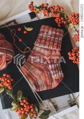 Hand knitted socks with needles and yarn ball. Concept for handmade and hygge slow life. 139013151