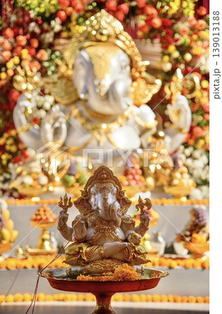 Ornate Lord Ganesha Idol with Golden Decorations for Hindu Festival Celebration and Puja Ornate Lord Ganesha Idol with Golden Decorations for Hindu Festival Celebration and Puja 139013188