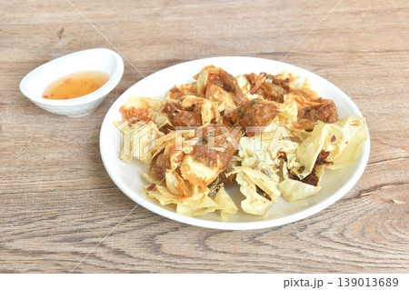 crispy fried dumpling tofu skin stuffed chop pork and shrimp dipping sweet plum sauce on plate 139013689