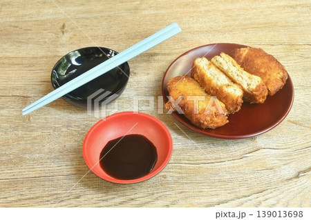 Menchi Katsu fried mashed pork with onion coating flake bread and egg dipping sweet shoyu sauce Japanese food on plate Menchi Katsu fried mashed pork with onion coating flake bread and egg dipping sweet shoyu sauce Japanese food on plate 139013698