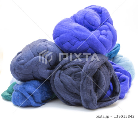 Multicolored skeins of merino wool on a white background Multicolored skeins of merino wool on a white background 139013842