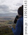 Woman hydrating during a highland mountain hike 139014143