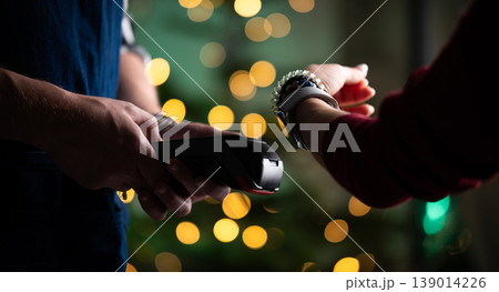 Girl Paying Bill With Watch Using Wireless Pos Terminal Girl Paying Bill With Watch Using Wireless Pos Terminal 139014226