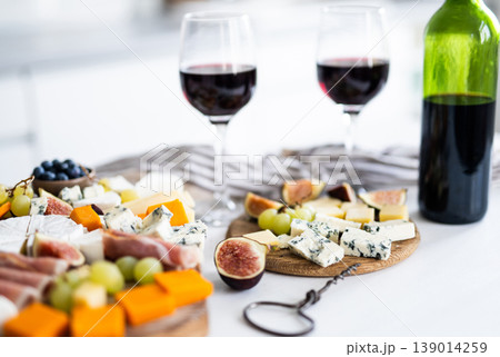 Cheese Plate Appetizer With Bottle Of Red Wine 139014259