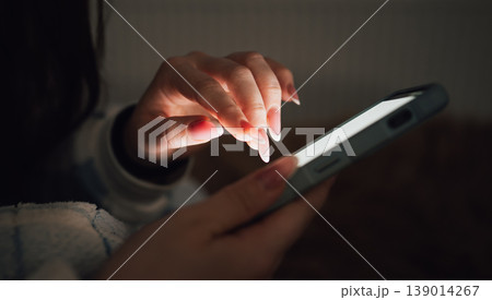 Young Girl Uses Smartphone at Home During Evening Hours 139014267