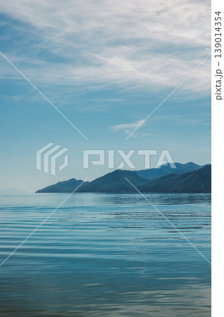Amazing view of Skadar Lake and beautiful mountains on a sunny morning. Travel destination in Montenegro. Amazing view of Skadar Lake and beautiful mountains on a sunny morning. Travel destination in Montenegro. 139014354