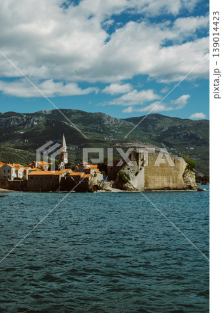 Amazing view of old Budva and St.Nicholas island and the sea near Budva. Beautiful cloudy sky. Amazing view of old Budva and St.Nicholas island and the sea near Budva. Beautiful cloudy sky. 139014423